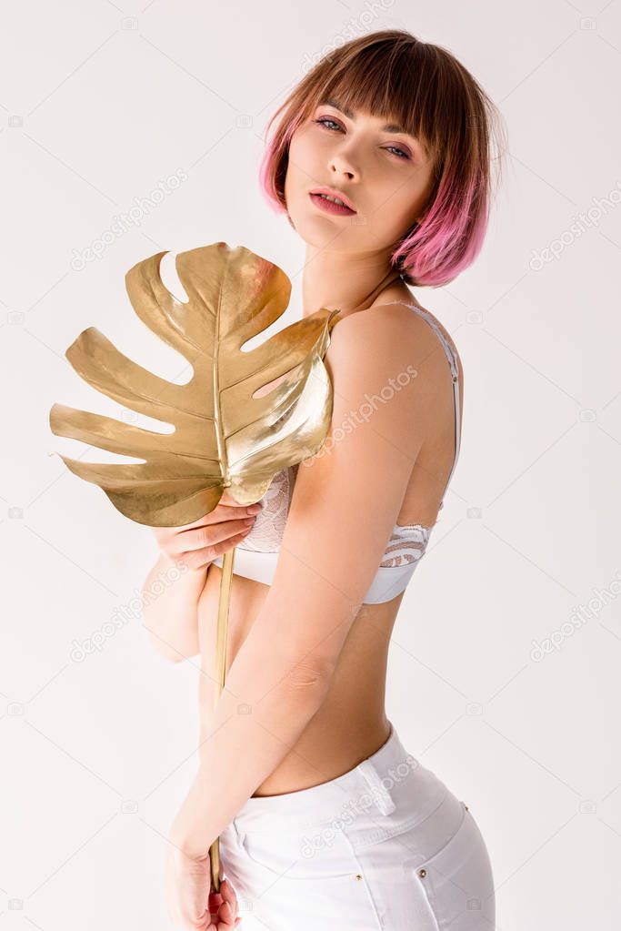woman posing with golden leaf 