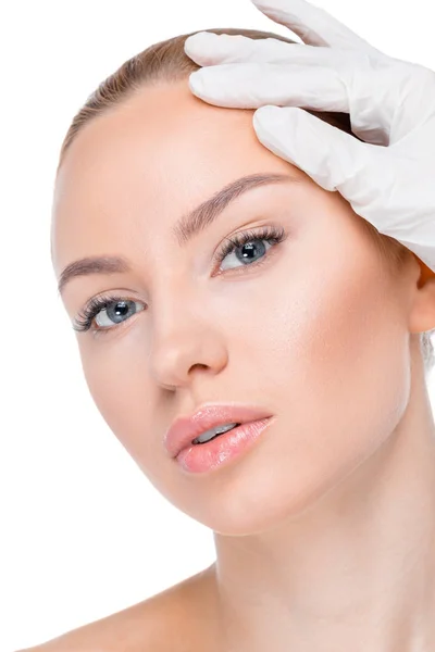 Cosmetologist examining face of patient — Stock Photo