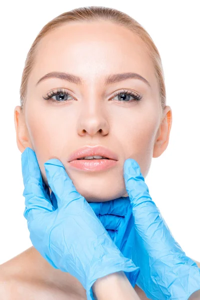 Cosmetologist examining chin of patient — Stock Photo