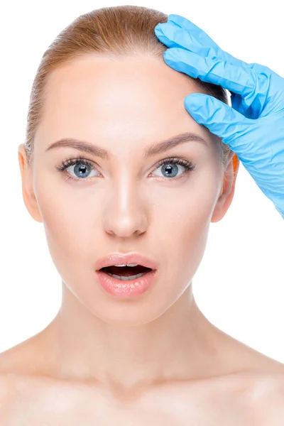 Cosmetologist examining face of patient — Stock Photo