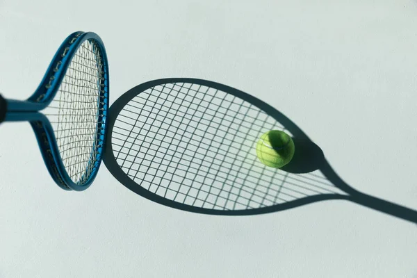 Tennis racket and ball on floor — Stock Photo