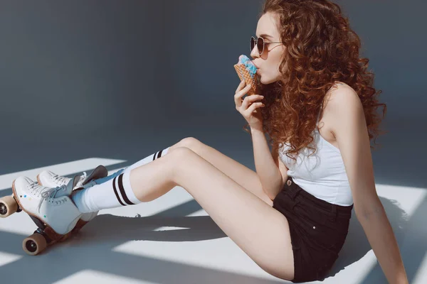 Girl in sunglasses eating ice cream — Stock Photo