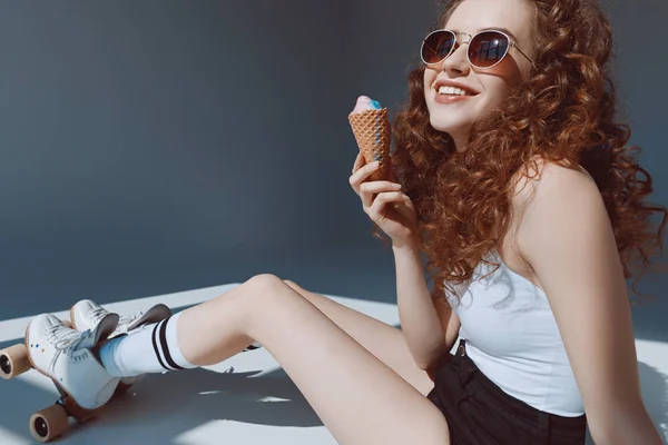 Девушка в солнечных очках ест мороженое — стоковое фото