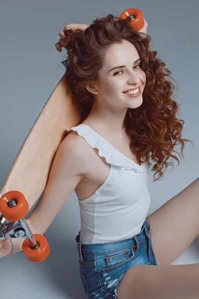 Hipster girl with skateboard — Stock Photo