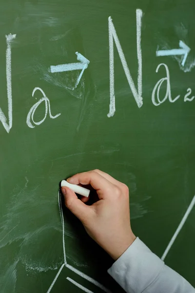 Schoolchild drawing chemical formula — Stock Photo