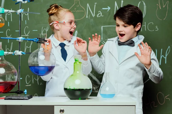 Kids in white coats in laboratory — Stock Photo