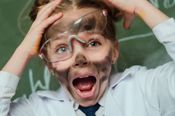 Shocked girl in lab coat — Stock Photo