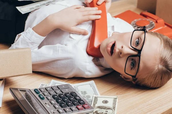 Kid with telephone tube at workplace — Stock Photo