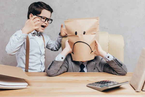 Kid screaming on friend at workplace — Stock Photo