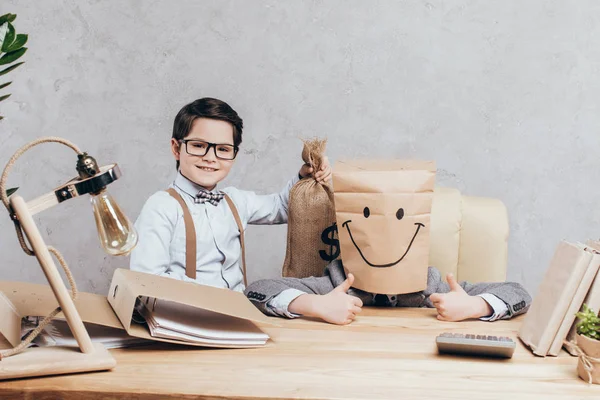 Kids with money bag at workplace — Stock Photo