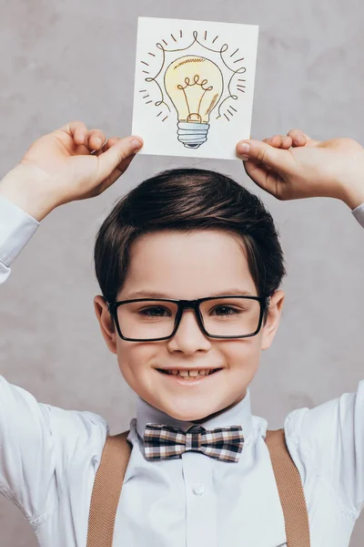 Child holding card with idea sign — Stock Photo