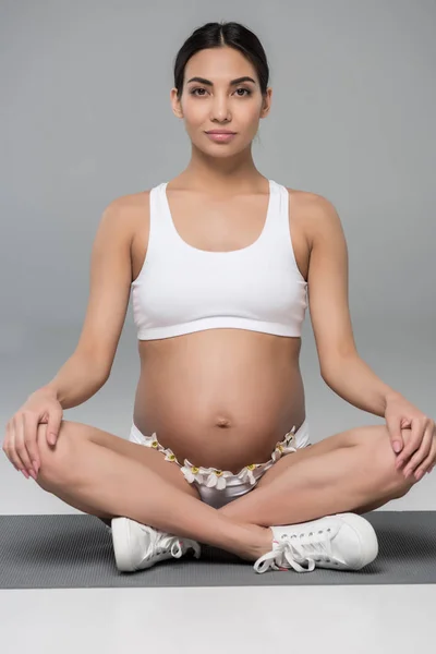 Pregnant woman in lotus pose — Stock Photo
