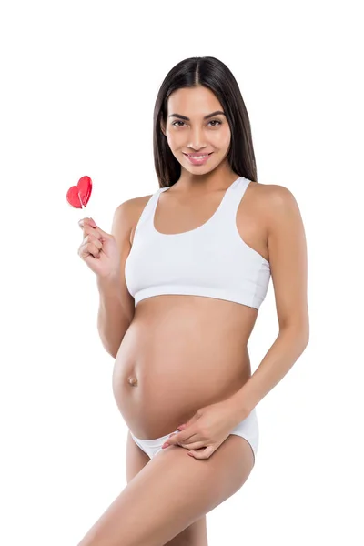 Pregnant woman with lollipop — Stock Photo