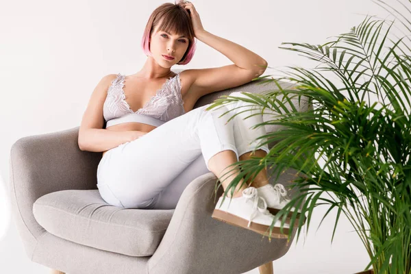 Young woman posing in armchair — Stock Photo