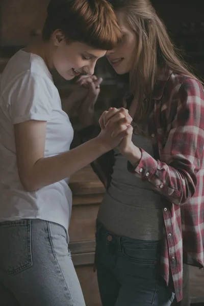 Happy young lesbian couple dancing and holding hands — Stock Photo