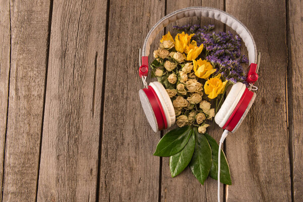 headphones and flowers on table 