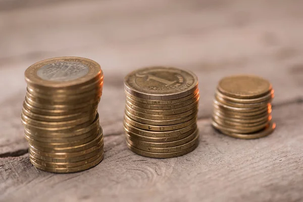 Stacks of coins on wooden tabletop — Stock Photo, Image