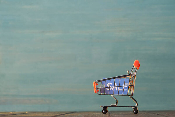 small shopping cart with sale sign