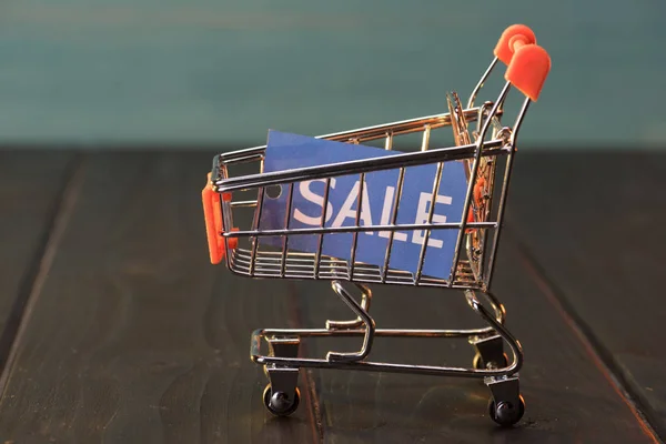 Small shopping cart with sale sign — Stock Photo, Image