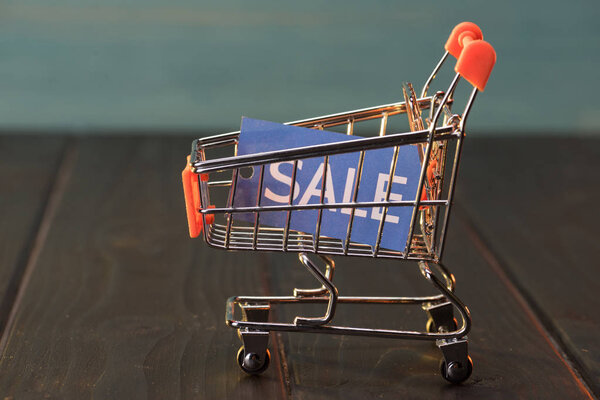 small shopping cart with sale sign
