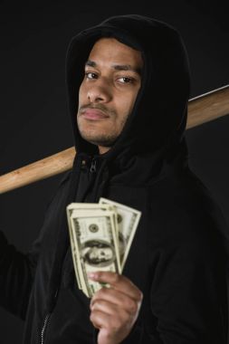 robber with baseball bat and money