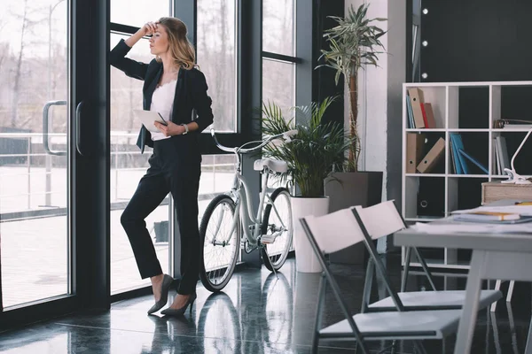 Pensive businesswoman with digital tablet — Stock Photo, Image