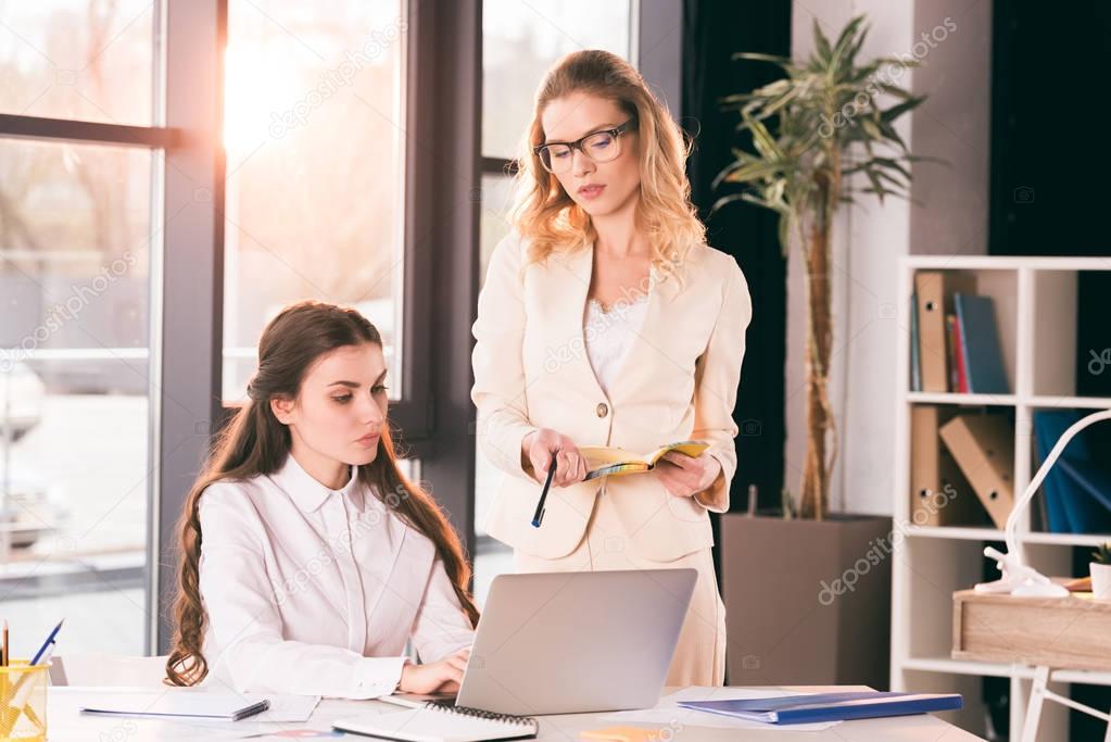 young businesswomen talking while working at office