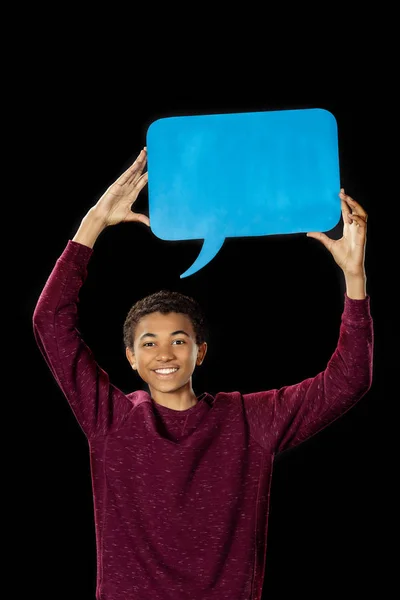 Boy holding blank speech bubble — Free Stock Photo