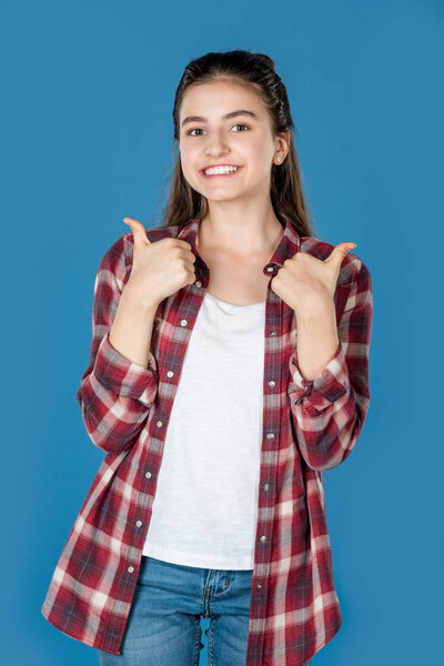 teen girl showing thumb up