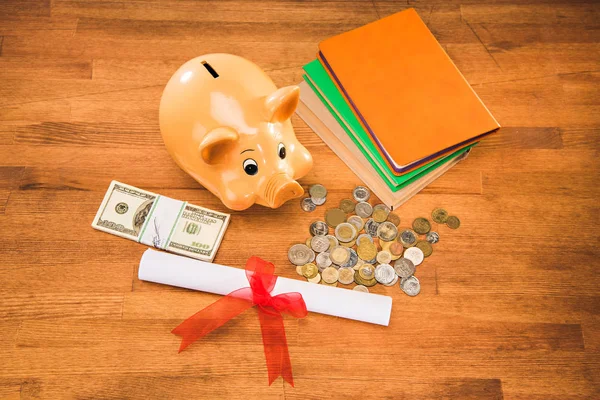 Diploma and piggy bank — Stock Photo