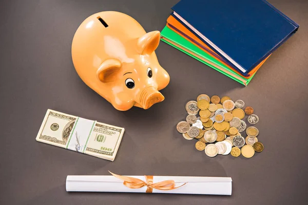 Diploma and piggy bank — Stock Photo