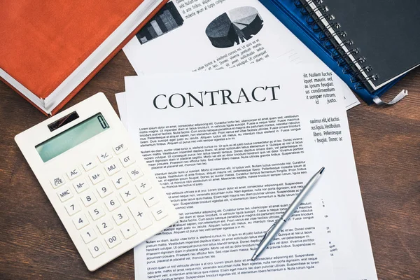 Contract and calculator at workplace — Stock Photo
