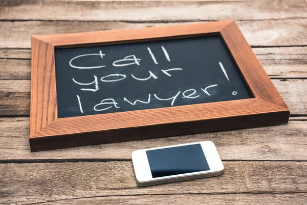 Smartphone and chalkboard in wooden frame — Stock Photo