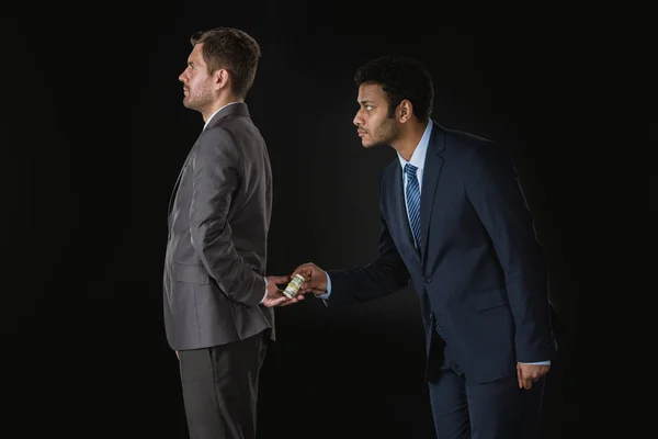 Businessman bribing partner — Stock Photo