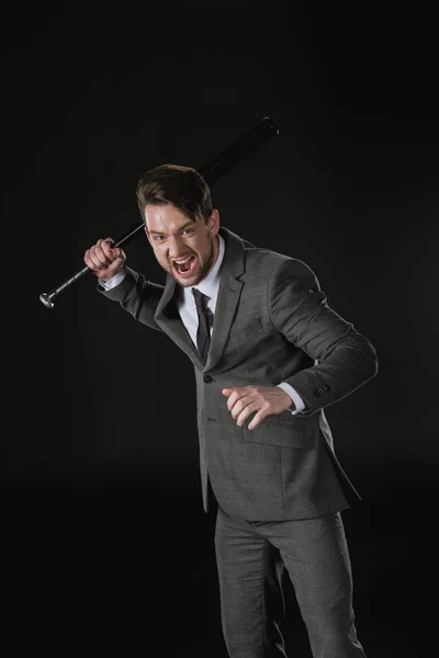 Angry businessman with bat — Stock Photo