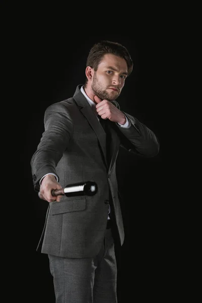 Serious businessman with bat — Stock Photo