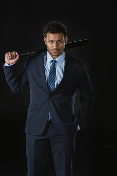 Serious businessman with bat — Stock Photo