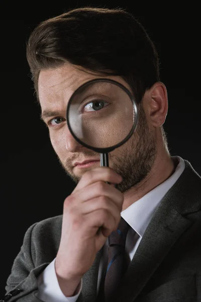 Businessman with magnifying glass — Stock Photo