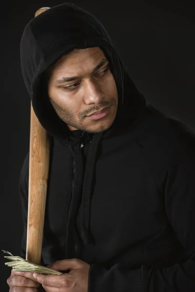 Robber with baseball bat and money — Stock Photo