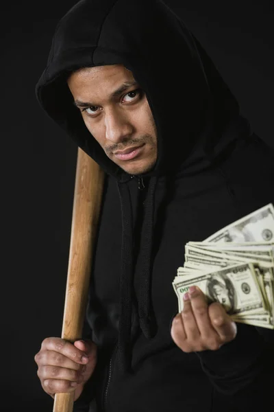 Robber with baseball bat and money — Stock Photo