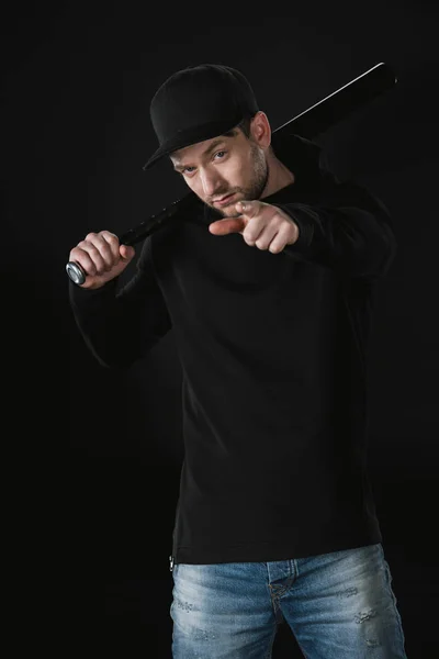 Young robber in zoodie with baseball bat — Stock Photo