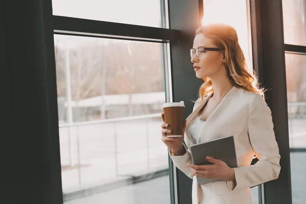 Pensive businesswoman with digital tablet — Stock Photo