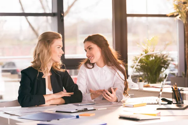 Colleagues using digital smartphone — Stock Photo