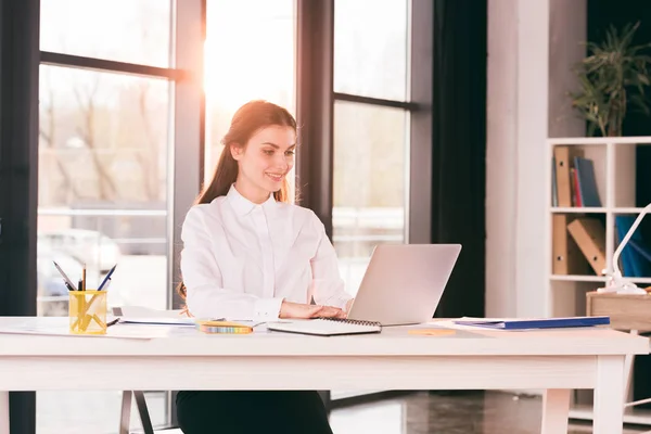 Businesswoman working on laptop in office — Stock Photo