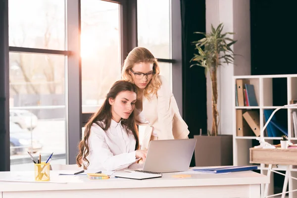 Young businesswomen talking while working at office — Stock Photo