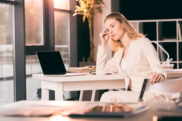 Junge Geschäftsfrau sitzt im Büro am Tisch — Stockfoto