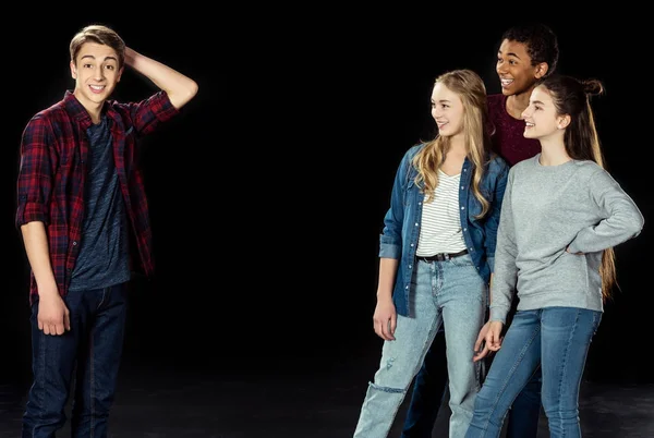 Teens looking at bewildered young boy — Stock Photo