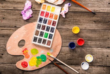 paints and palette on table clipart