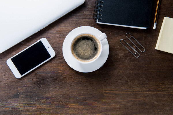 Coffee cup and smartphone on desk 