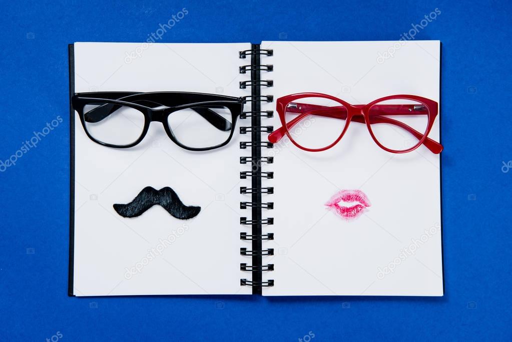 pairs of glasses on notebook